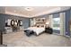Spacious main bedroom featuring neutral carpeting, bright windows, and modern decor at 10414 Trellis Lane (Lot 36), Hampton, GA 30228