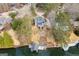 Aerial view of a home with waterfront property including a boat dock and lakeside landscaping at 1190 Plantation Dr, Villa Rica, GA 30180