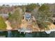 Aerial view of grey lake house, landscaped yard, and covered dock on the water at 1190 Plantation Dr, Villa Rica, GA 30180