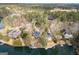 Lakefront homes aerial view surrounded by dense trees and calm water at 1190 Plantation Dr, Villa Rica, GA 30180