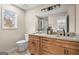 Well-lit bathroom featuring a dual vanity with granite countertops, a large mirror, and a glass shower at 1190 Plantation Dr, Villa Rica, GA 30180