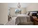 Bedroom features a large window with lake views, and a stylish globe chandelier at 1190 Plantation Dr, Villa Rica, GA 30180