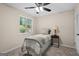 Comfortable bedroom with neutral tones, a ceiling fan, a side table, and natural light from the window at 1190 Plantation Dr, Villa Rica, GA 30180