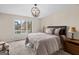 Bedroom features large window with lake view, carpet and a stylish chandelier at 1190 Plantation Dr, Villa Rica, GA 30180