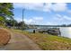 Picturesque lake view with multiple boat slips and a paved walking path along the shore at 1190 Plantation Dr, Villa Rica, GA 30180