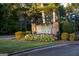 Elegant stone community sign 'Fairfield Plantation' surrounded by vibrant flowers and lush greenery at 1190 Plantation Dr, Villa Rica, GA 30180