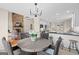 Open concept features a dining area with round table and woven chairs next to the living room at 1190 Plantation Dr, Villa Rica, GA 30180