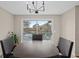 Bright dining area features stylish chandelier and sliding glass door to deck and lake views at 1190 Plantation Dr, Villa Rica, GA 30180