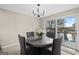 Bright dining area features a round table with woven chairs and a sliding glass door to the deck at 1190 Plantation Dr, Villa Rica, GA 30180