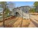 View of home exterior with stairs and lakeside yard at 1190 Plantation Dr, Villa Rica, GA 30180