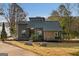Contemporary home featuring stone accents and a well-manicured front yard with lake views at 1190 Plantation Dr, Villa Rica, GA 30180