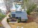 Beautiful lake house with stone and siding, a well-manicured lawn, and a driveway at 1190 Plantation Dr, Villa Rica, GA 30180
