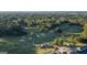 Scenic aerial view of a lush golf course surrounded by mature trees and landscaping at 1190 Plantation Dr, Villa Rica, GA 30180