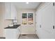 Bright hallway with tile floors, white cabinets, gray countertops and a view to the street at 1190 Plantation Dr, Villa Rica, GA 30180
