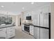 Bright kitchen with stainless steel appliances and an open dining area with access to an outdoor deck at 1190 Plantation Dr, Villa Rica, GA 30180