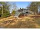 Screened-in porch home exterior with staircases and landscaped yard on a sunny day at 1190 Plantation Dr, Villa Rica, GA 30180