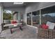 Relaxing screened porch features a comfortable seating area and stylish decor, perfect for enjoying the outdoors at 1190 Plantation Dr, Villa Rica, GA 30180