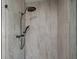 Modern shower featuring tiled walls, matte-black shower head, handheld sprayer, and clear glass enclosure at 1190 Plantation Dr, Villa Rica, GA 30180
