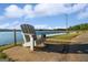 Relaxing waterfront view with Adirondack chair near the Dockside Marina Restaurant and Bar on a sunny day at 1190 Plantation Dr, Villa Rica, GA 30180