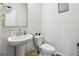 Small bathroom with a white pedestal sink, standard toilet, and neutral wall color at 6910 Newcastle Ct, Fairburn, GA 30213