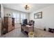 Home office with bright window, carpeted floors, and a functional wooden desk at 6910 Newcastle Ct, Fairburn, GA 30213