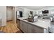 Open-concept kitchen featuring stainless steel appliances, a central island, and a view into the living room at 6910 Newcastle Ct, Fairburn, GA 30213