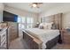 Cozy main bedroom with a large wooden bed, shutters, and ample natural light at 6910 Newcastle Ct, Fairburn, GA 30213