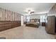 Spacious main bedroom featuring wood accent wall, neutral carpet, and ceiling fan at 6910 Newcastle Ct, Fairburn, GA 30213