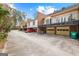 Rear exterior view featuring garages and balconies, with brick facade at 180 Habersham Pl, Fayetteville, GA 30214