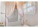 Bathtub and shower with a window and patterned wallpaper at 180 Habersham Pl, Fayetteville, GA 30214
