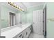 Bright bathroom features a large mirror, white cabinets, and a single sink at 180 Habersham Pl, Fayetteville, GA 30214
