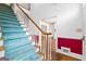 View of the entryway featuring a staircase with blue carpet and paneled walls at 180 Habersham Pl, Fayetteville, GA 30214