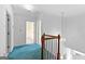 Hallway with teal carpet and a decorative hanging light fixture at 180 Habersham Pl, Fayetteville, GA 30214