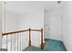 Upstairs hallway with wood railing and a hanging decorative chandelier at 180 Habersham Pl, Fayetteville, GA 30214