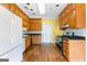 A kitchen featuring wood cabinets, black countertops, and stainless steel appliances at 180 Habersham Pl, Fayetteville, GA 30214