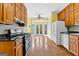 Spacious kitchen featuring wood cabinets, tile backsplash, and stainless steel appliances at 180 Habersham Pl, Fayetteville, GA 30214