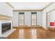 Bright living room with hardwood flooring, a marble fireplace, and plantation shutters at 180 Habersham Pl, Fayetteville, GA 30214
