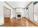 Spacious living room featuring hardwood floors, a fireplace, and classic trim work at 180 Habersham Pl, Fayetteville, GA 30214