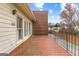 Exterior patio features red brick flooring, white walls and a black railing at 180 Habersham Pl, Fayetteville, GA 30214