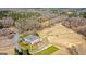 Expansive aerial view showcasing the clubhouse, golf course, and surrounding natural landscape at 560 Birkdale Dr, Fayetteville, GA 30215