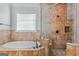 Luxurious bathroom with separate tub and shower featuring detailed tile work and elegant fixtures at 560 Birkdale Dr, Fayetteville, GA 30215