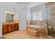 The bathroom features double vanities, a separate shower, and a luxurious soaking tub at 560 Birkdale Dr, Fayetteville, GA 30215