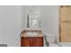 Cozy bathroom with wooden vanity, laminate countertop, a toilet, and a mirror at 560 Birkdale Dr, Fayetteville, GA 30215