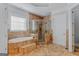 The bathroom showcases a soaking tub, tiled walls, and a frameless glass shower at 560 Birkdale Dr, Fayetteville, GA 30215