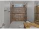 Bathroom showcasing tile surround, granite countertop, and a small window at 560 Birkdale Dr, Fayetteville, GA 30215