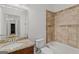 Bathroom featuring a granite vanity and tiled shower and tub combination, offering style and functionality at 560 Birkdale Dr, Fayetteville, GA 30215