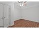 Bedroom features wood floors, ceiling fan and double door closet, perfect for storage and relaxation at 560 Birkdale Dr, Fayetteville, GA 30215