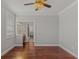 Bedroom with hardwood floors, neutral walls, ceiling fan, and connecting bathroom with tiled shower at 560 Birkdale Dr, Fayetteville, GA 30215