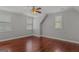 Spacious bedroom with wood floors, a ceiling fan, and natural light from two windows at 560 Birkdale Dr, Fayetteville, GA 30215