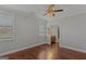 Bedroom with hardwood floors, neutral walls, ceiling fan, and connecting bathroom with granite vanity at 560 Birkdale Dr, Fayetteville, GA 30215